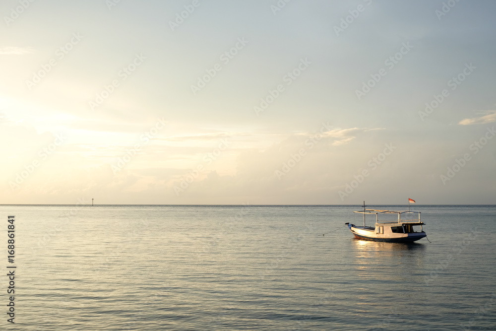 small fisher boat on java sea at sunrise