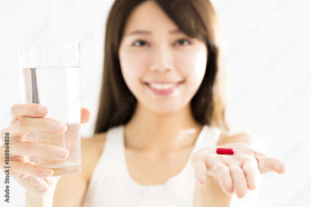 smiling young woman showing pill in hand smiling young woman showing pill in hand