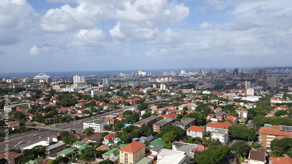 Panoramic shot of Durban city showing main road, with sea and harbour in the distance.
