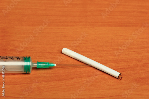 Creative Set of Medical Syringe on Wood Background