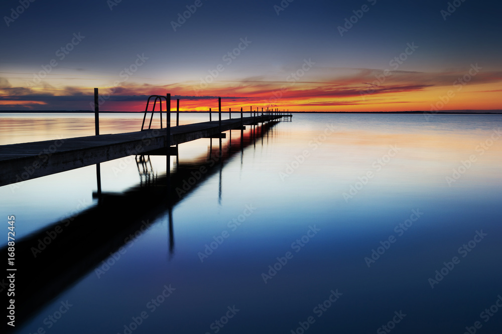 Landing stage by the sea at sunset