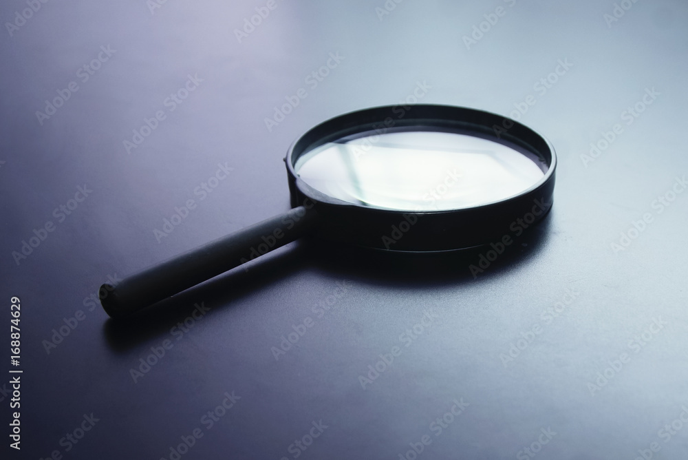 Magnifying Glass With Dramatic Light Setup Over Black Background Magnifying Glass With Dramatic Light Setup Over Black Background