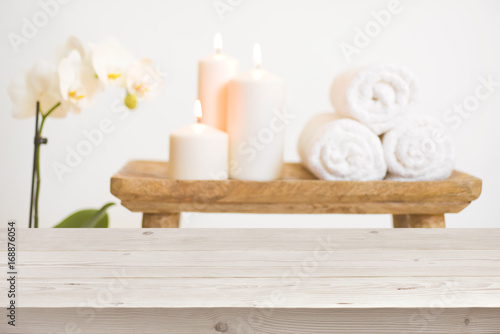 Wooden table in front of blurred background of spa products