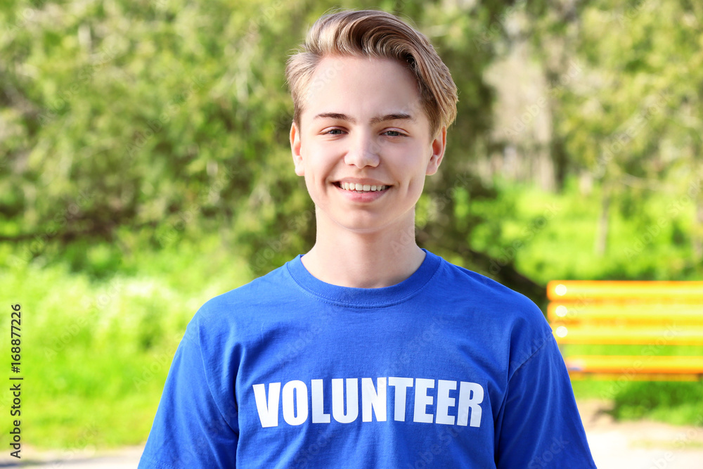 Young handsome boy standing outdoors. Volunteering concept Young handsome boy standing outdoors. Volunteering concept