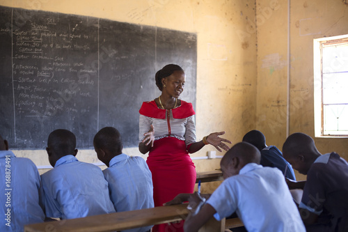 Teacher teaching children in classroom at school