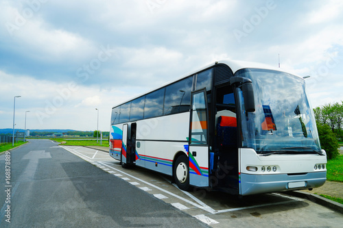 Modern bus with opened door on asphalt road