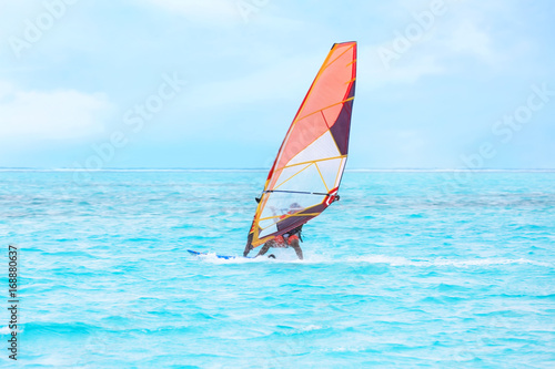 Tourist windsurfing at sea resort