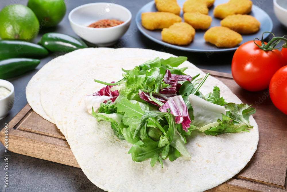Delicious fish taco with filling on  grey background, close up