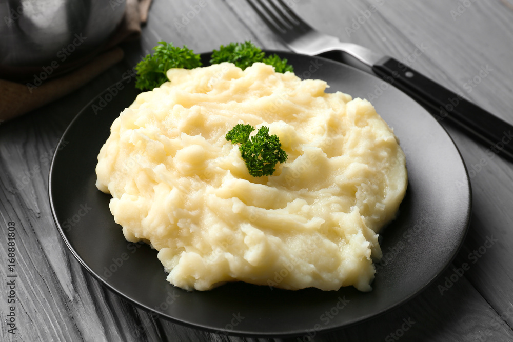 Plate with mashed potatoes on wooden table Plate with mashed potatoes on wooden table