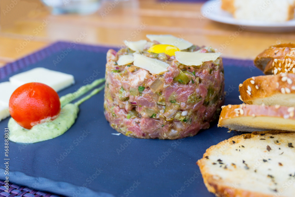 tasty Steak tartare (Raw beef) - classic steak tartare on white plate tasty Steak tartare (Raw beef) - classic steak tartare on white plate
