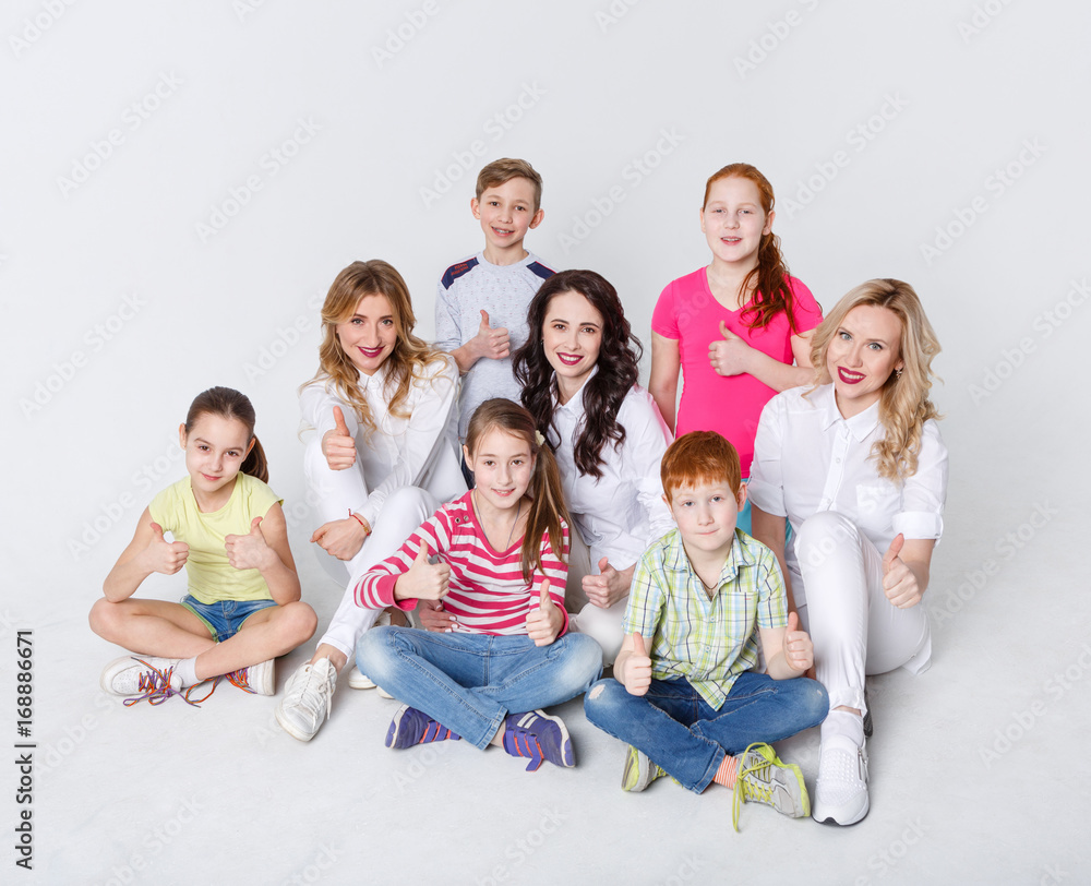 Happy kids and adults standing at white background, copy space Happy kids and adults standing at white background, copy space