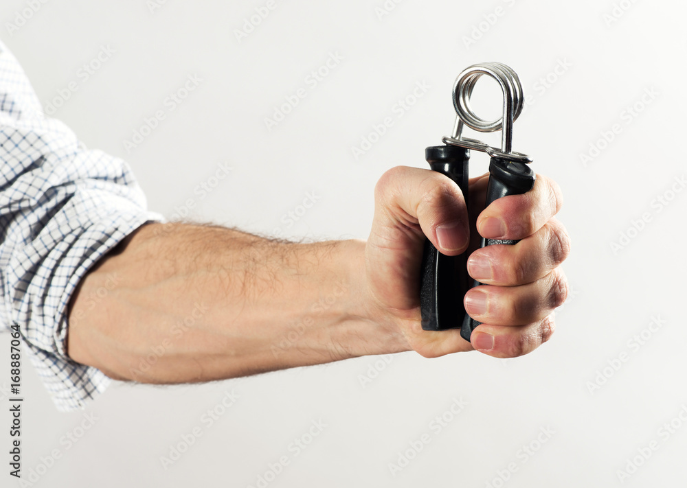 Man forcing together a strong spring Man forcing together a strong spring