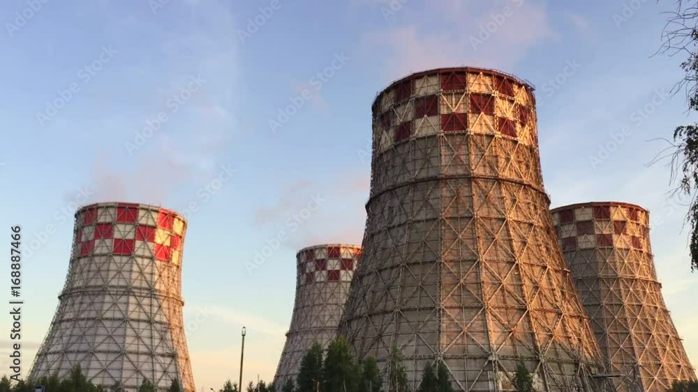 Cogeneration power plant in city. Thermal Power Station chimney smoke sky. Close-up. Sunset landscape. Combined heat power plant near megapolis. Chimney-stalk and ecology on Earth. Heat electricity. Cogeneration power plant in city. Thermal Power Station chimney smoke sky. Close-up. Sunset landscape. Combined heat power plant near megapolis. Chimney-stalk and ecology on Earth. Heat electricity.