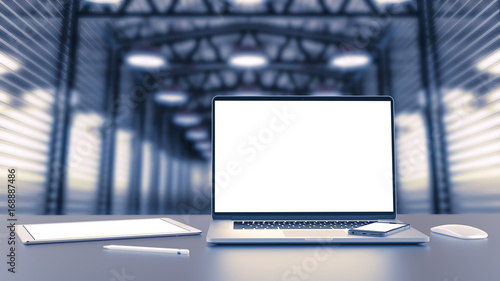 Laptop, tablet, smartphone, mouse,and pencil on the background of the hall.