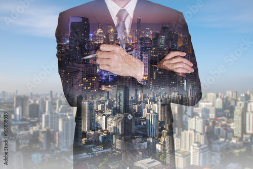 Double exposure of businessman think idea, cityscape,urban in the night and the day as business and leadership concept. © ImagineDesign