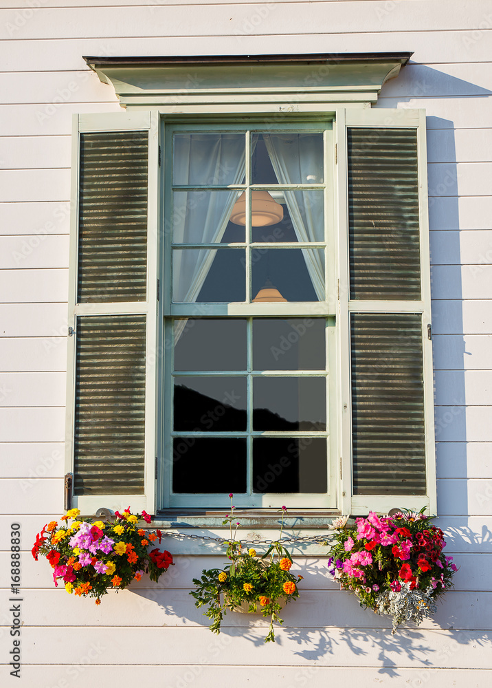 Wooden window with flower pot.