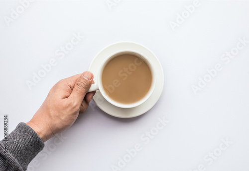 Male hand holding cup of coffee.business and drink concept