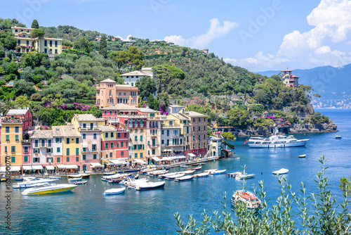 Beautiful aerial daylight view from top to ships on water and buildings in Portofino city of Italy. Tourists walking on sidewalk. Top view © frimufilms