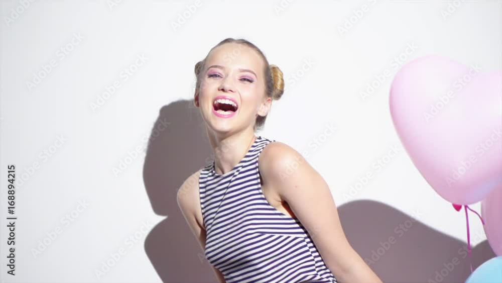 Beauty girl with colorful air balloons spinning and laughing. Happy young woman on birthday holiday party. Slow motion 240 fps. 4K UHD video 3840x2160 Beauty girl with colorful air balloons spinning and laughing. Happy young woman on birthday holiday party. Slow motion 240 fps. 4K UHD video 3840x2160