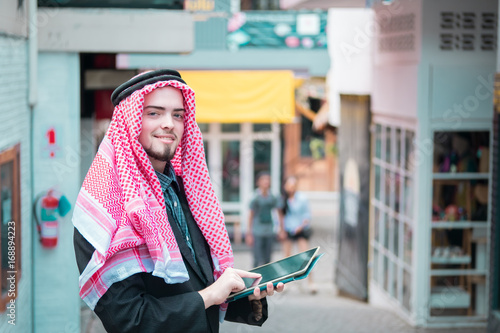 Arab business man standing and working at his market, business concept