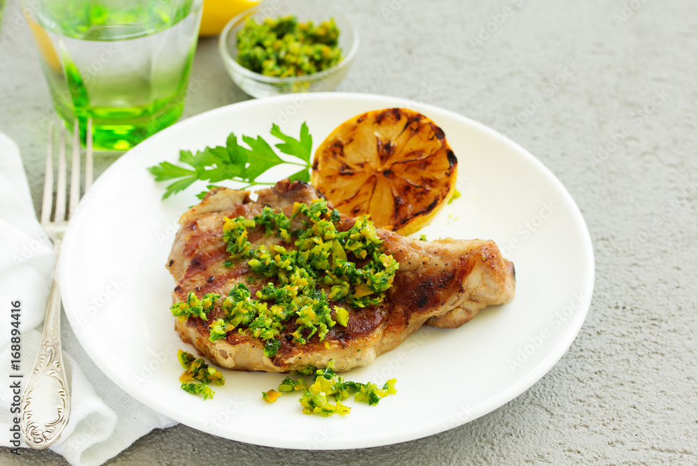 Pork cutlet on a bone with gremolat sauce. Pork cutlet on a bone with gremolat sauce.