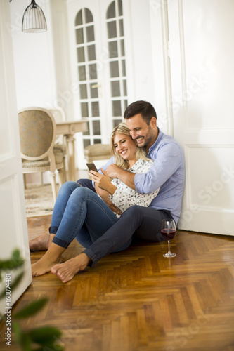 Young couple sits on the fl...