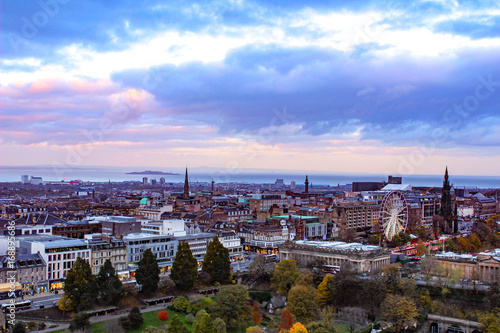 Vibrant Sunset view of Edinburgh Scotland with autumn leaves.