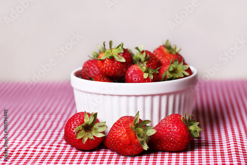  Fresh Strawberries in White Bowl on Red Gingham Tablecloth