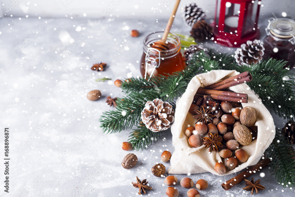 Festive christmas nuts and spices tumbling from a burlap bag Festive christmas nuts and spices tumbling from a burlap bag