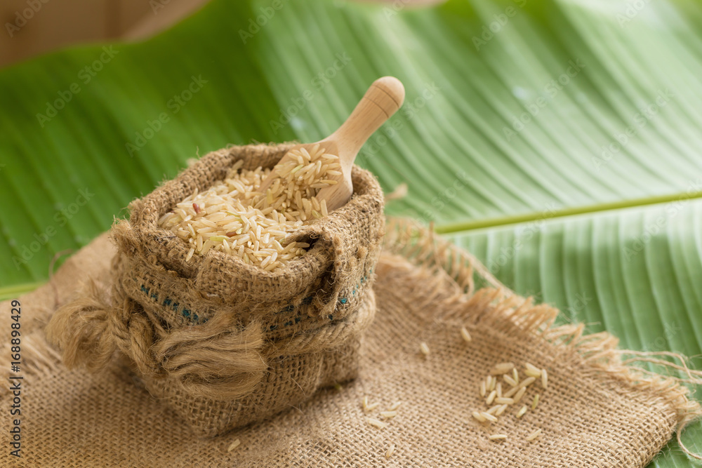 Brown rice in sacks on banana leaves Brown rice in sacks on banana leaves