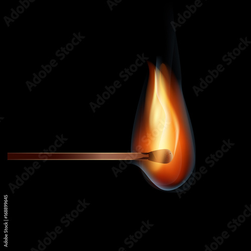 burning wooden match on a black background