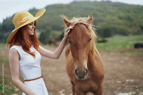Woman with a horse in a hat © SHOTPRIME STUDIO