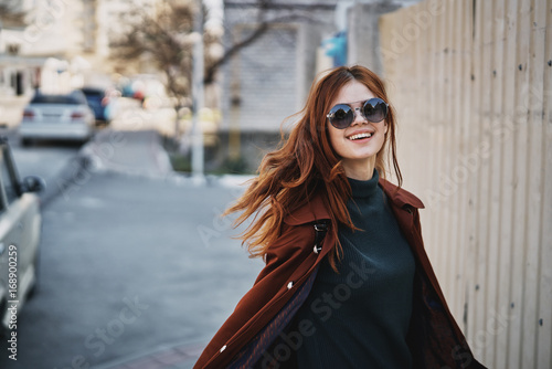 Woman in sunglasses on the street in the city in autumn