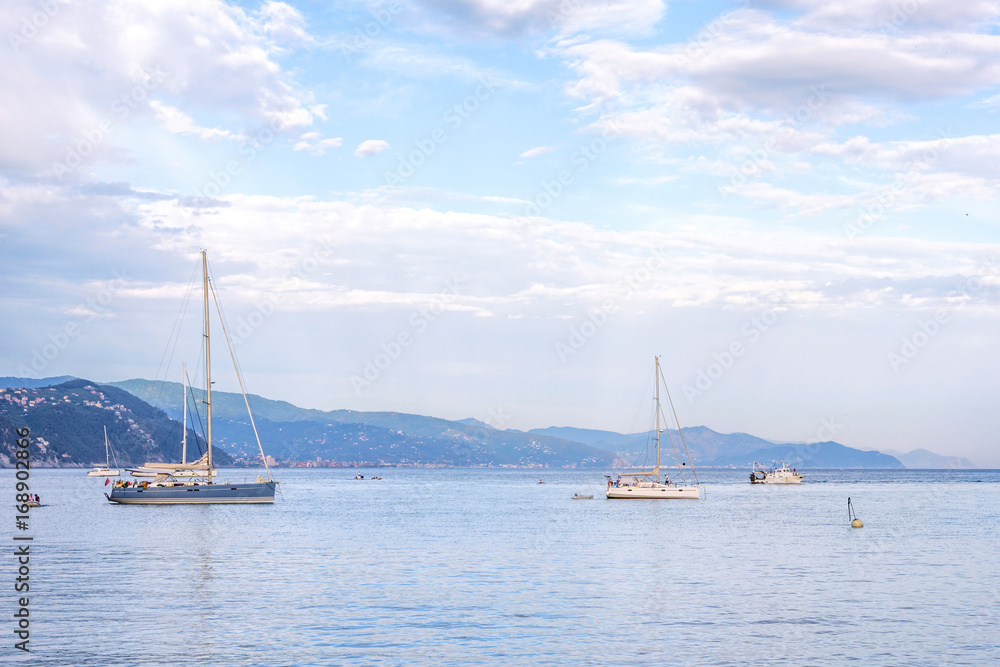 Fototapeta premium Daylight beautiful view to ships cruising on water and blue sky. Santa Margherita Ligure, Italy