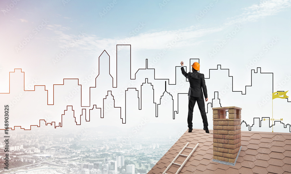 Man architect draw silhouette of modern city on blue sky. Mixed media Man architect draw silhouette of modern city on blue sky. Mixed media