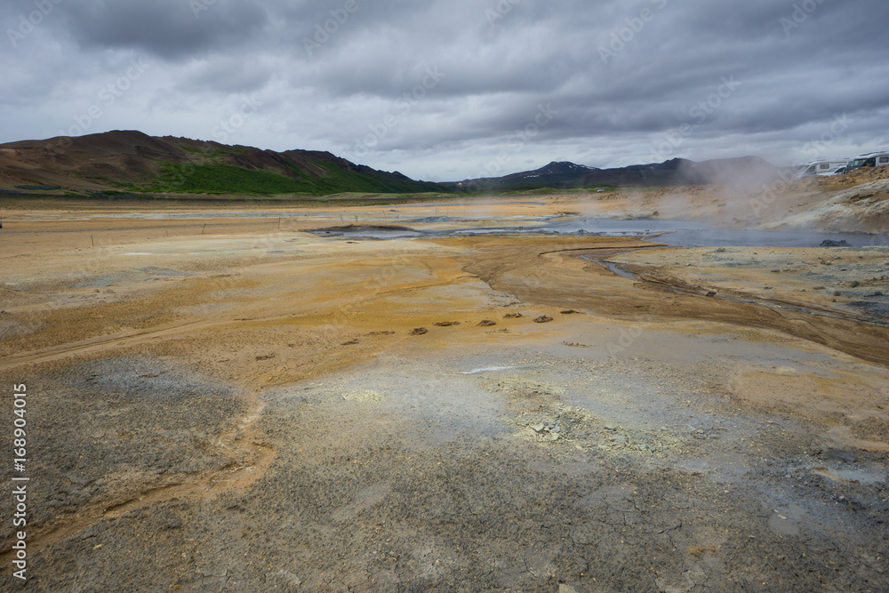 Iceland - Hot spring and mud pots at geothermal area hverir near myvatn and green volcanoes Iceland - Hot spring and mud pots at geothermal area hverir near myvatn and green volcanoes