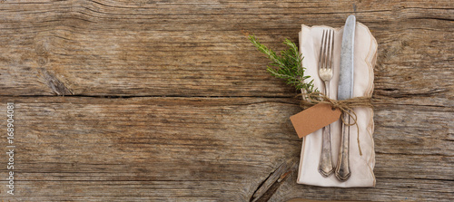 Table setting with tag on wooden background