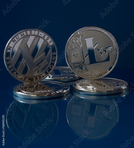 Litecoins on the blue glass background - virtual crypto currency photo