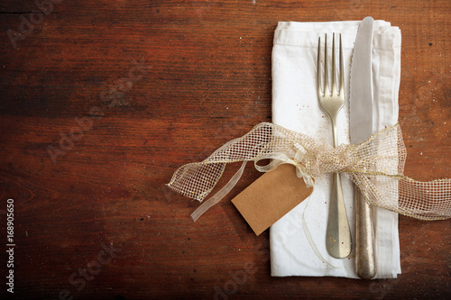 Table setting with tag on wooden background
