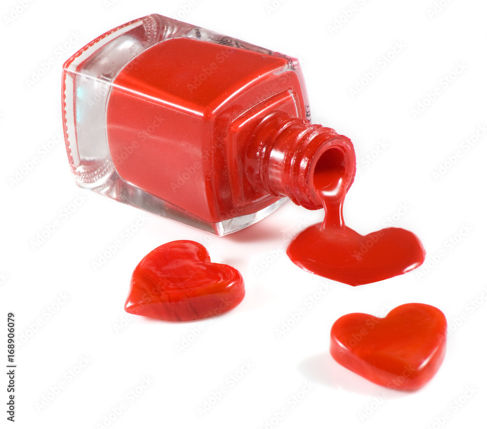 isolated image of red nail polish and heart on a white background isolated image of red nail polish and heart on a white background