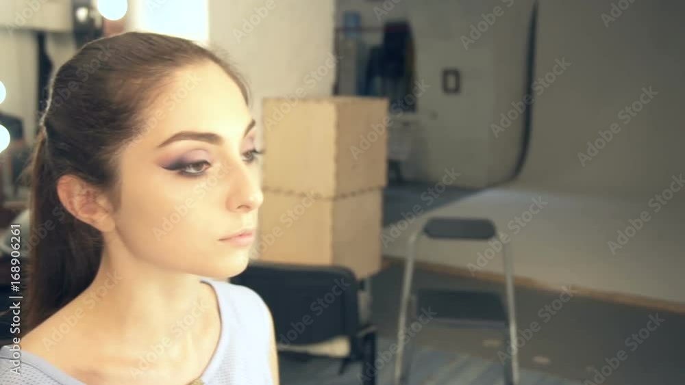 Young beautiful woman applying make-up by make-up artist Young beautiful woman applying make-up by make-up artist