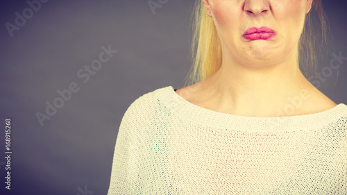 Woman having disgusted face expression