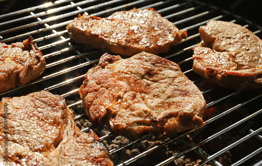 Tasty steaks on barbecue grill Tasty steaks on barbecue grill