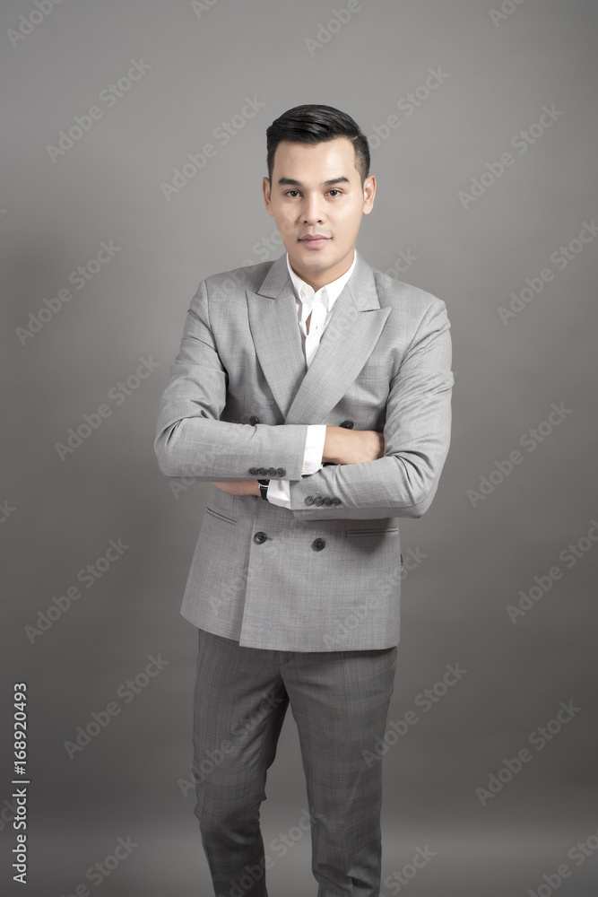 Businessman is smart, portrait in studio grey background Businessman is smart, portrait in studio grey background