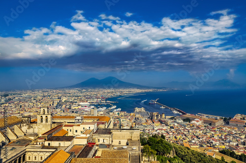 Obraz na płótnie Italy. Cityscape of Naples (UNESCO World Heritage Site) seen from Castle Sant'Elmo. There is Certosa e Museo di San Martino in the foreground and Mount Vesuvius in the background w salonie