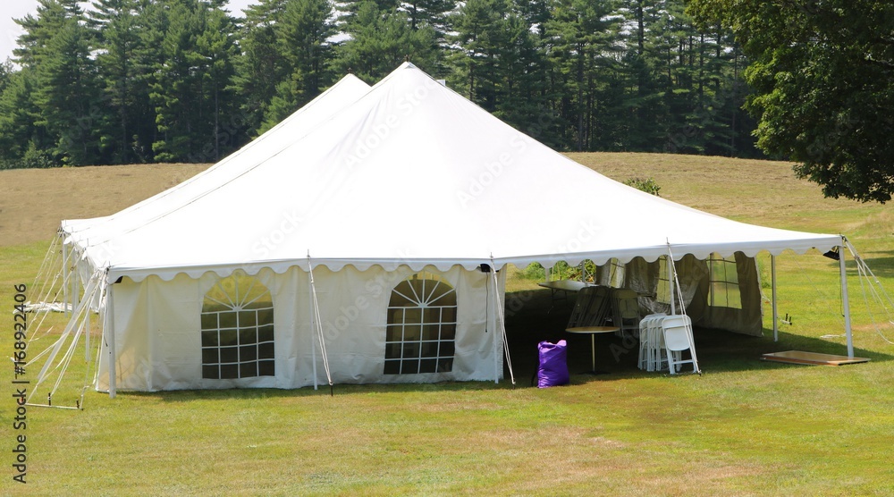 large white events or wedding tent in field