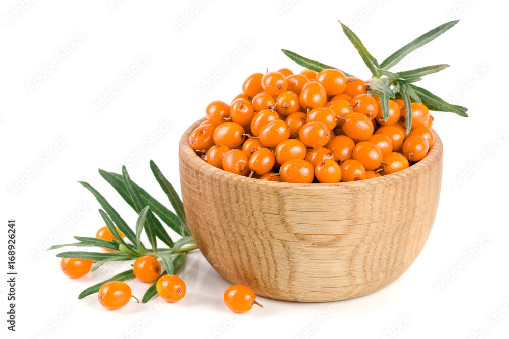 Sea buckthorn. Fresh ripe berry with leaves in a wooden bowl isolated on white background macro Sea buckthorn. Fresh ripe berry with leaves in a wooden bowl isolated on white background macro