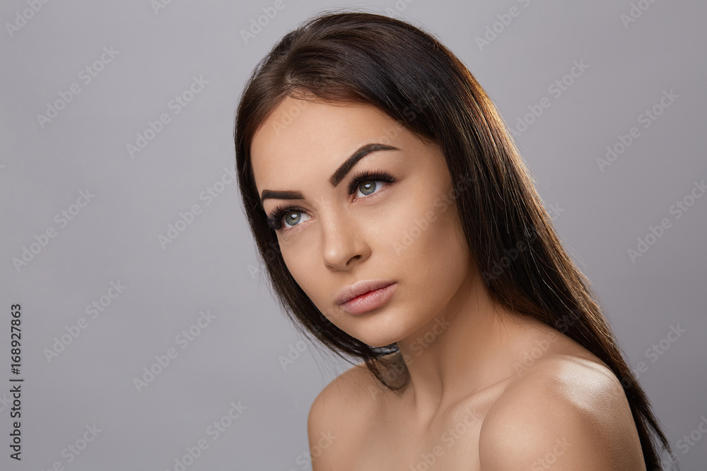 Eyelashes extensions. Fake Eyelashes. Closeup Of Beautiful Young Female Model With Soft Smooth Skin And Professional Facial Makeup. Portrait Of Sexy Girl With Long Fake Eyelashes And Perfect Make-up. Eyelashes extensions. Fake Eyelashes. Closeup Of Beautiful Young Female Model With Soft Smooth Skin And Professional Facial Makeup. Portrait Of Sexy Girl With Long Fake Eyelashes And Perfect Make-up.