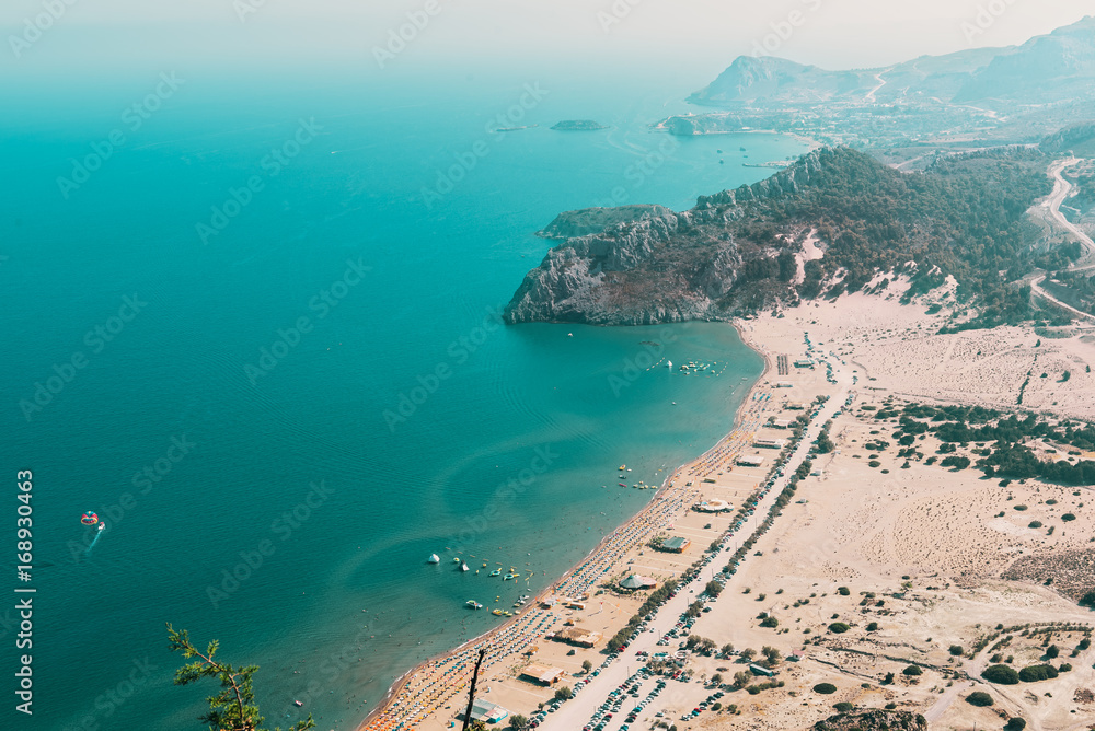 Aerial view on Tsampika sandy beach and lagoon with clear blue water at Rhodes island, Greece.