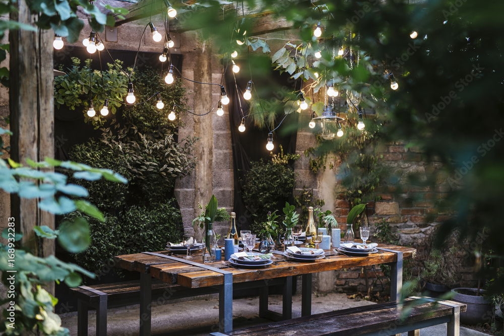 © Lumina/Stocksy - Decorated Outdoor Dining Table
